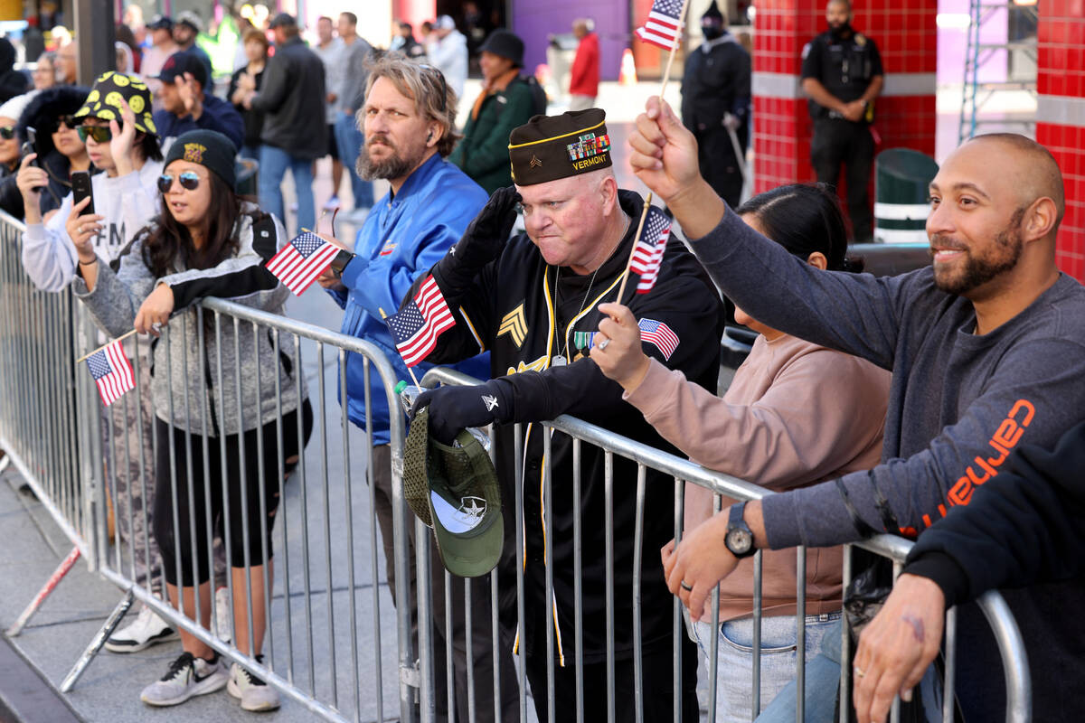 Tim Kemp of Las Vegas, center, salutes during the Veterans Day parade on Fourth Street in downt ...