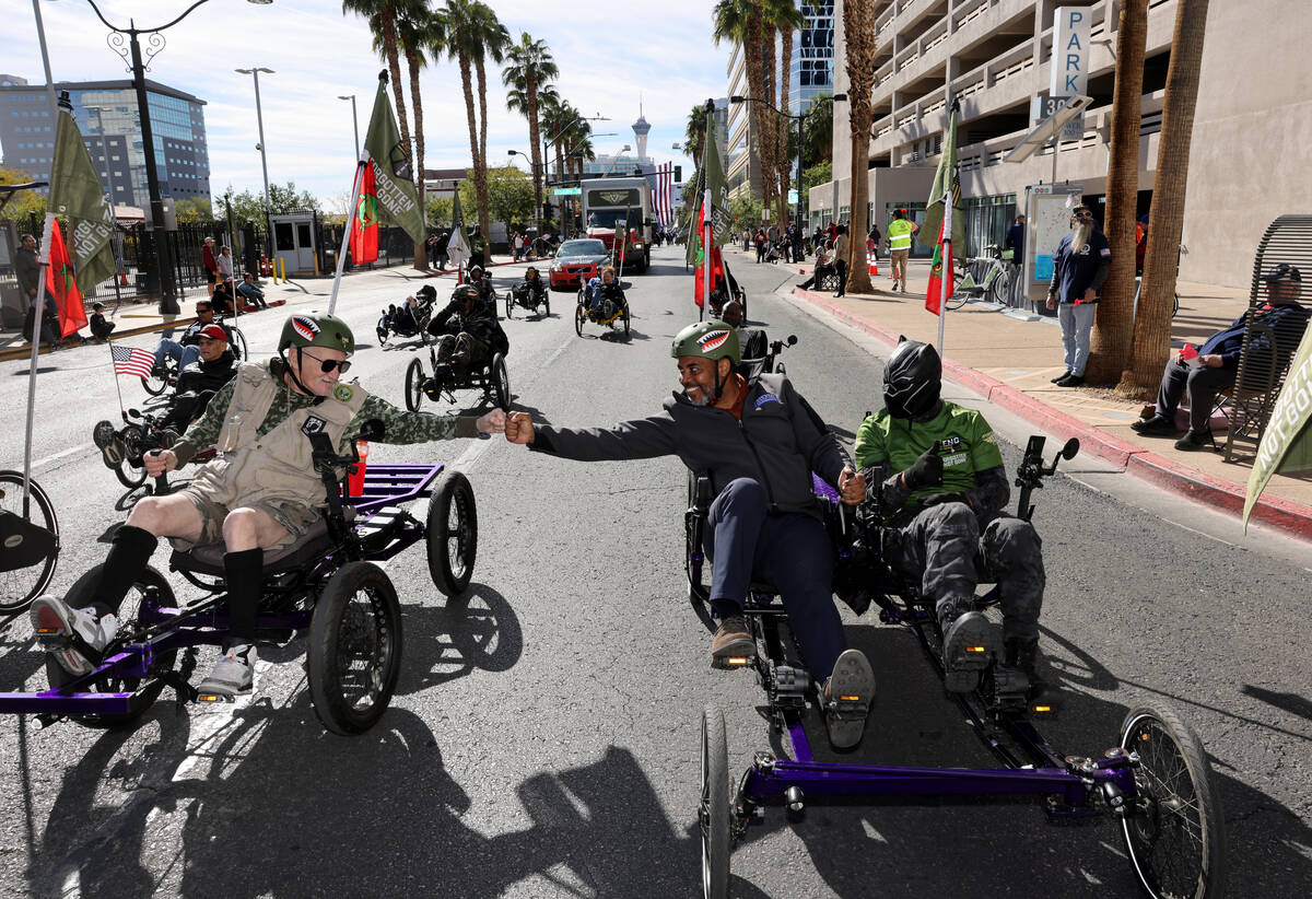 U.S. Rep. Steven Horsford, D-Nev., right, fist pumps Army veteran Ian Campbell while riding in ...