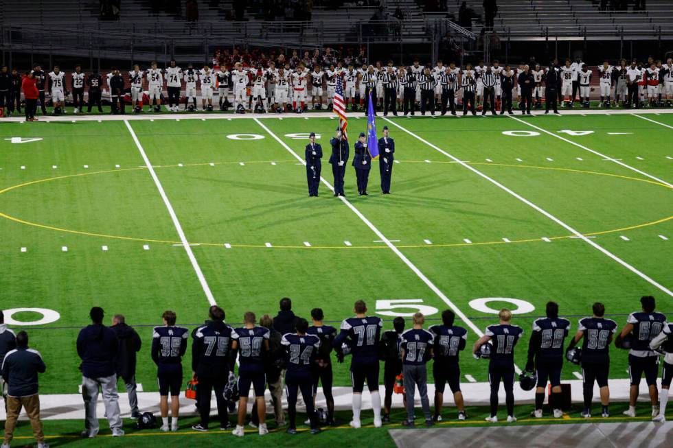 Shadow Ridge High School players, foreground and Las Vegas High School players line up for the ...