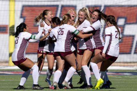 Faith Lutheran surrounds their Brooklyn Maier, center right, after she scored the game-winning ...