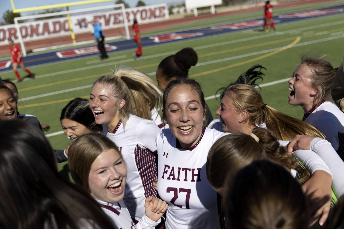 Faith Lutheran players including Madeline Mariani (27) celebrate after winning the Class 5A gir ...