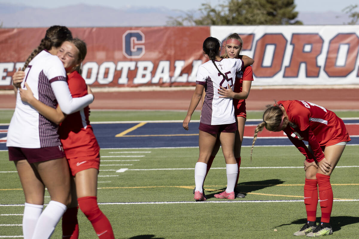 Faith Lutheran players console disappointed Coronado players after they beat them in the Class ...