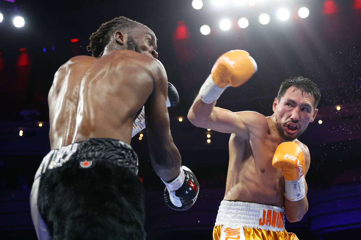 Janibek Alimkhanuly, right, battles Denzel Bentley in the sixth round of a WBO middleweight tit ...