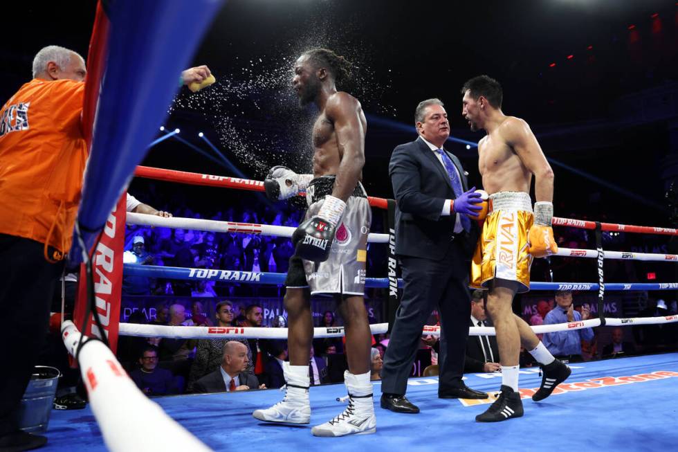 Denzel Bentley, left, and Janibek Alimkhanuly, walk to a corner following their WBO middleweigh ...