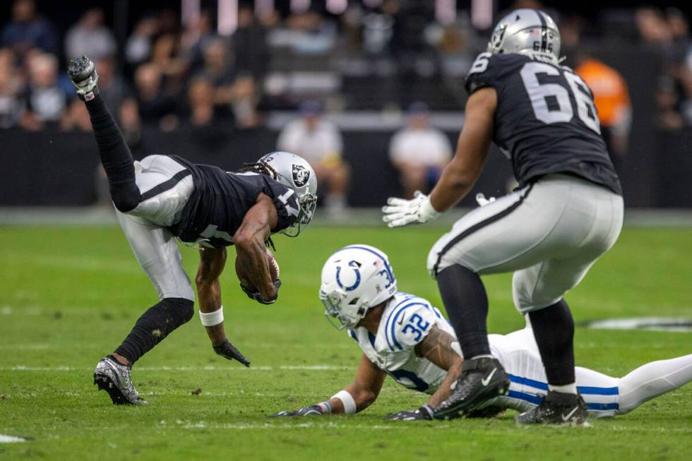 Las Vegas Raiders wide receiver Davante Adams (17) dives for more yardage with Indianapolis Col ...