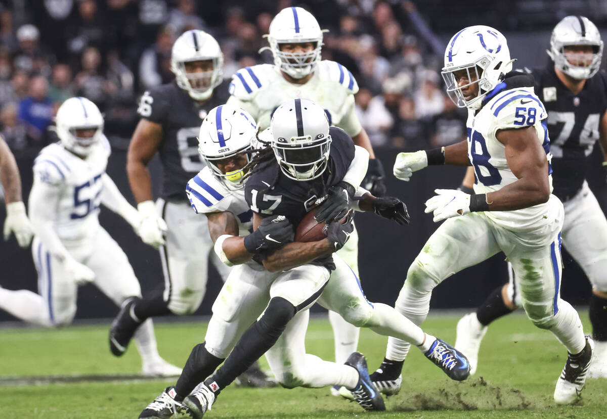 Raiders wide receiver Davante Adams (17) gets stopped by Indianapolis Colts safety Rodney McLeo ...