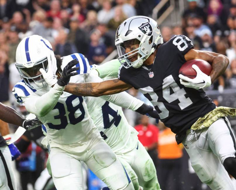 Raiders wide receiver Keelan Cole (84) stiff-arms Indianapolis Colts cornerback Tony Brown (38) ...