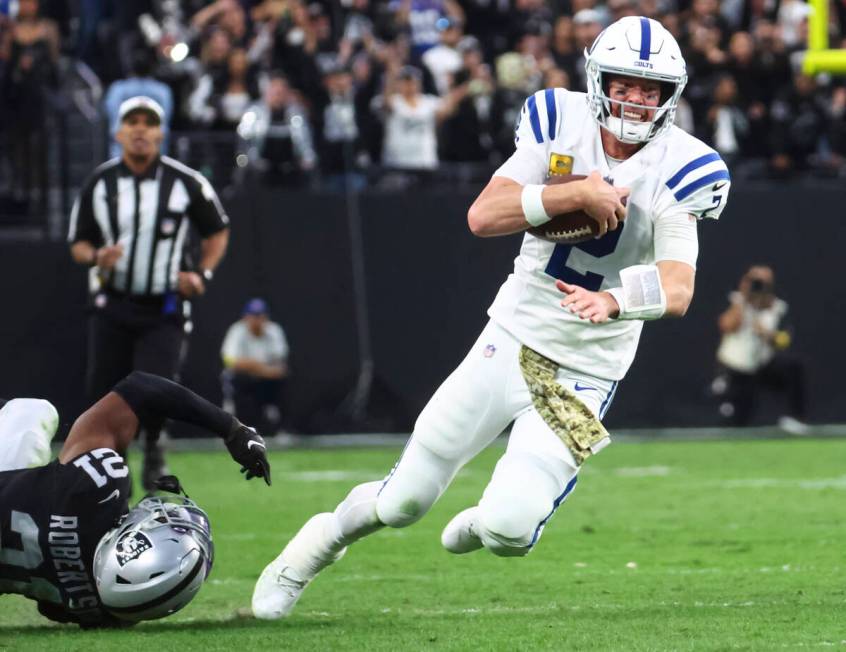 Indianapolis Colts quarterback Matt Ryan (2) runs the ball past Raiders cornerback Amik Roberts ...