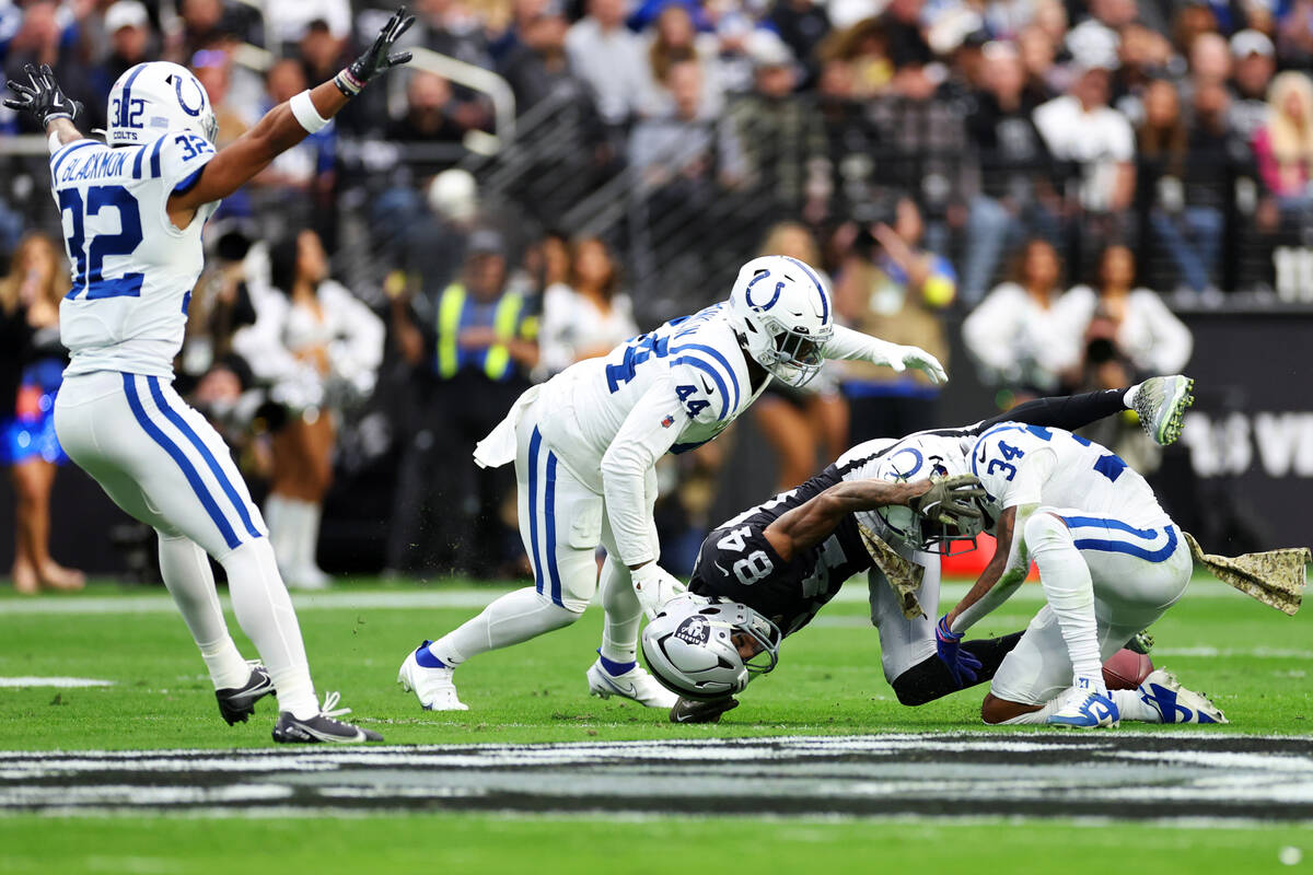 Raiders wide receiver Keelan Cole (84) drops a pass under pressure from Indianapolis Colts corn ...