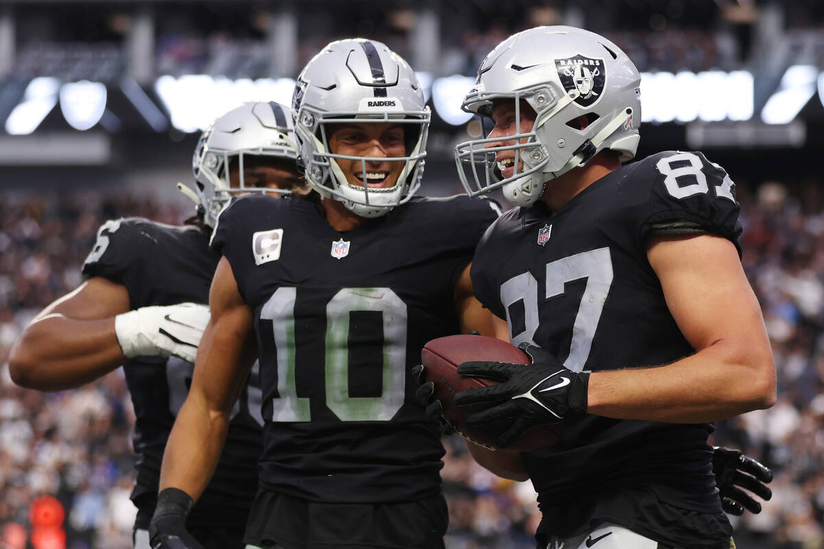 Raiders tight end Foster Moreau (87) celebrates his touchdown catch with wide receiver Mack Hol ...