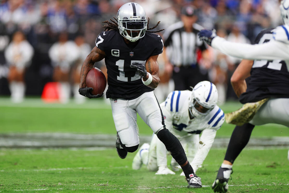 Raiders wide receiver Davante Adams (17) runs the ball against the Indianapolis Colts in the fi ...