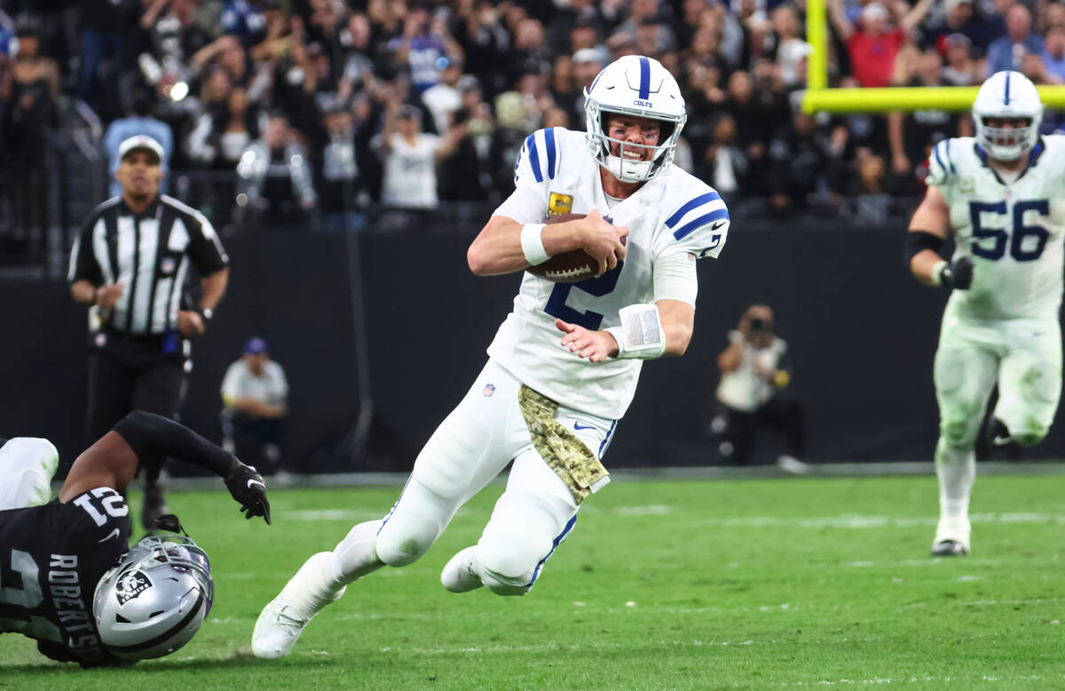 Indianapolis Colts quarterback Matt Ryan (2) runs the ball past Raiders cornerback Amik Roberts ...