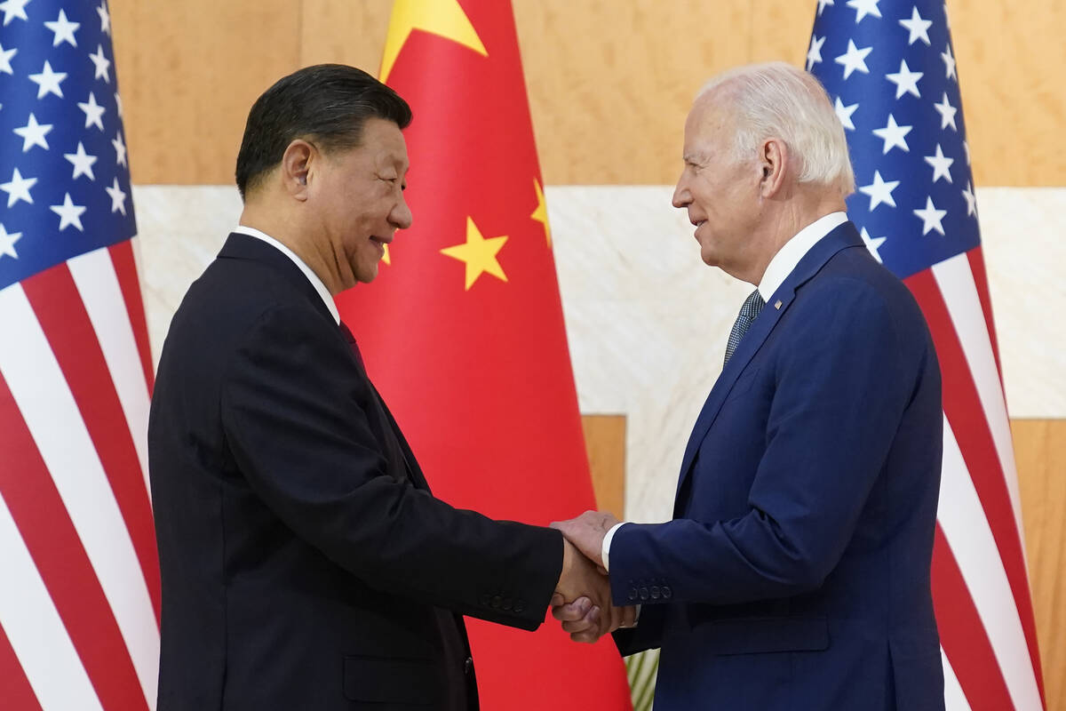 U.S. President Joe Biden, right, and Chinese President Xi Jinping shake hands before their meet ...