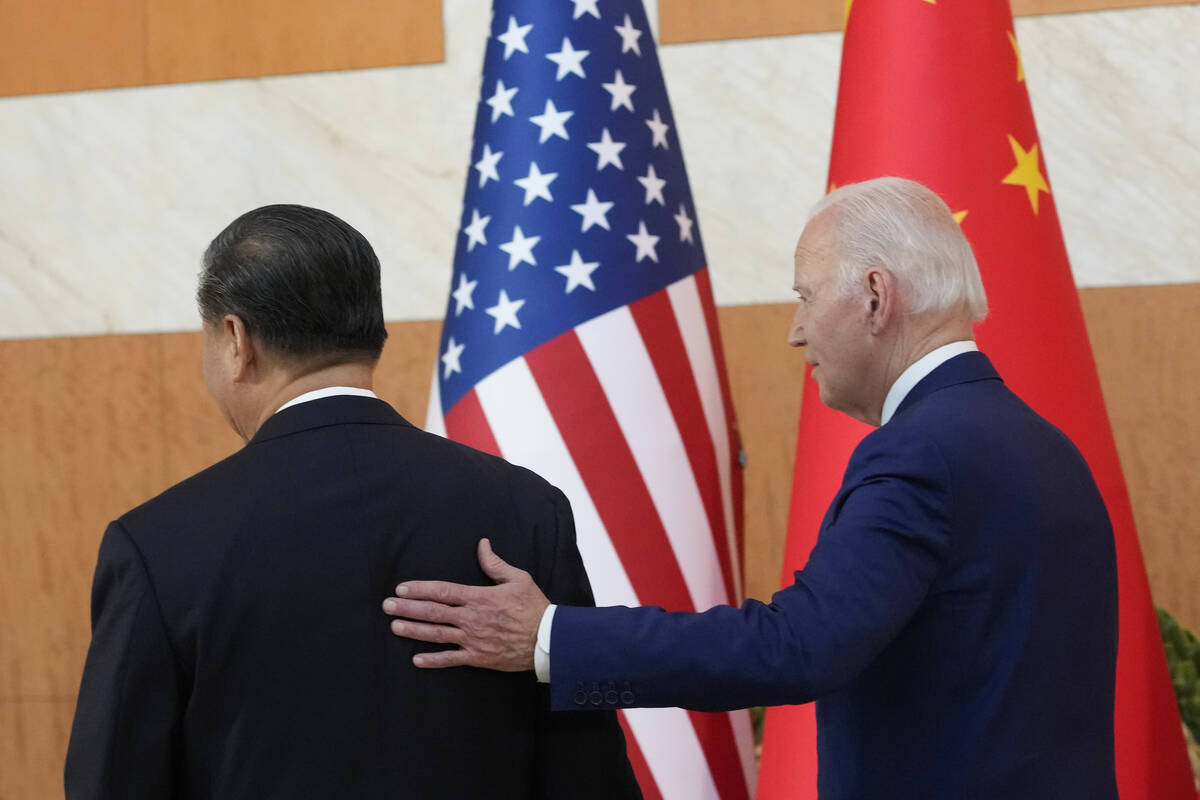 U.S. President Joe Biden, right, walks with Chinese President Xi Jinping before their meeting o ...