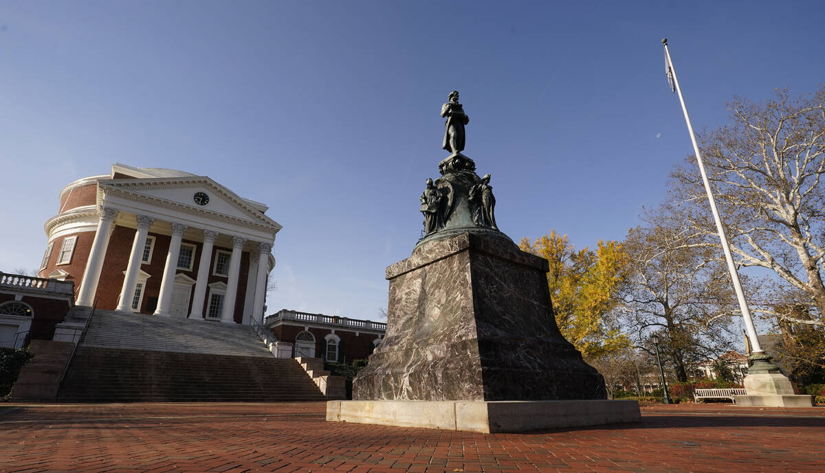 A statue of University of Virginia founder, Thomas Jefferson, stands watch over the Rotunda nea ...