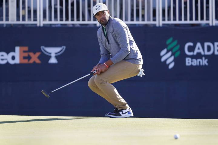 Tony Finau reacts as his putts just misses the cup on the 18th green during the final round of ...