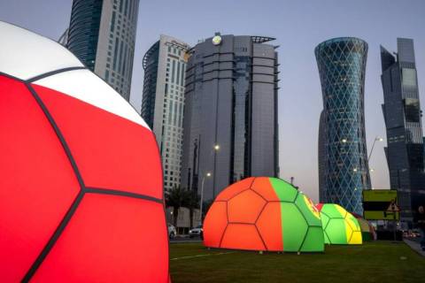 Domes featuring different national colors are displayed near the Doha Exhibition and Convention ...