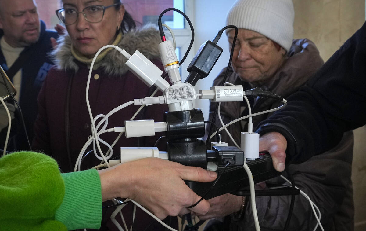 People charge their phones, try to connect to the internet and make phone calls, in central squ ...