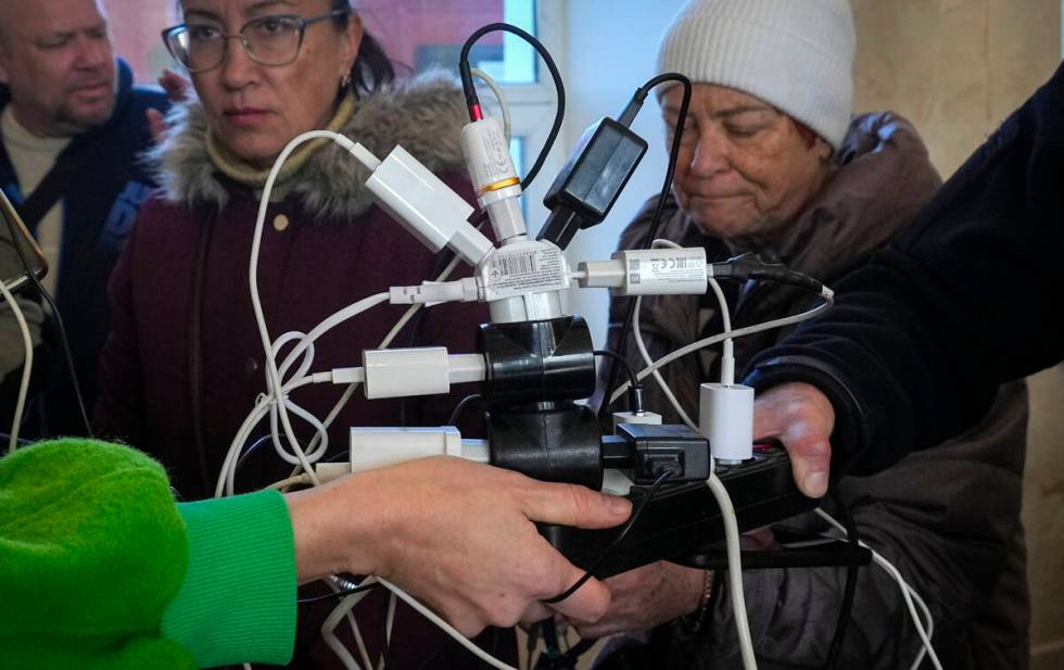 People charge their phones, try to connect to the internet and make phone calls, in central squ ...