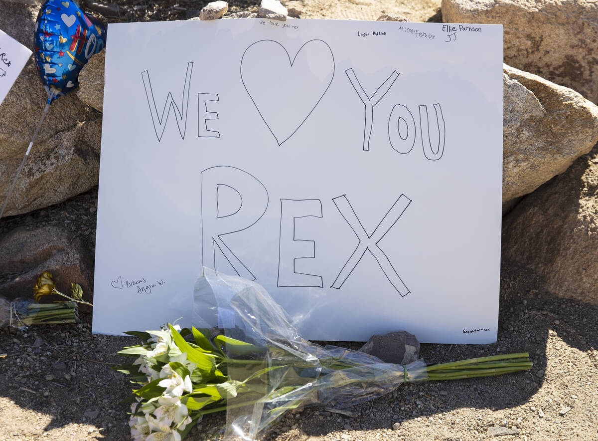 A “We Love You” note and a bouquet of flower are placed at a makeshift memorial o ...