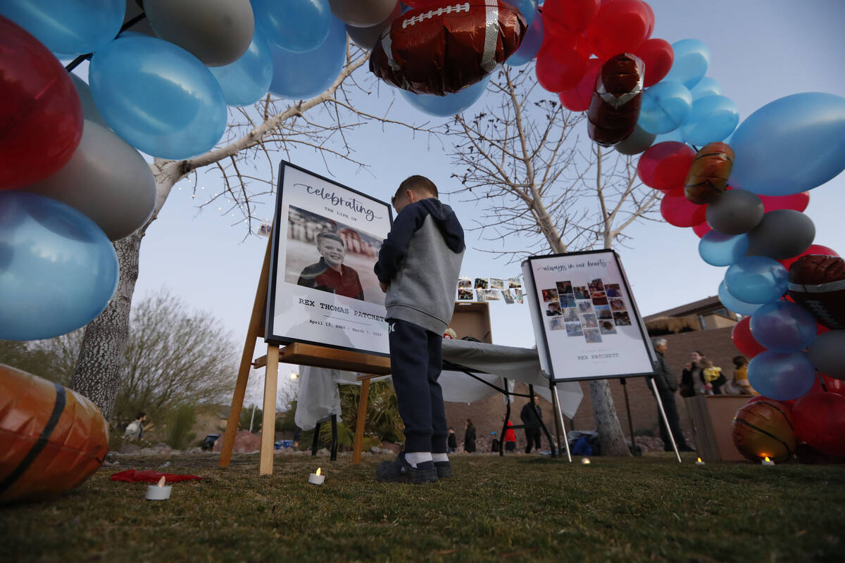 A boy pauses in front of a photo of Rex Patchett, Friday, March 11, 2022, during a remembrance ...