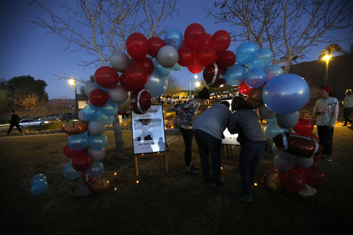 People see the photos of Rex Patchett, Friday, March 11, 2022, during a remembrance ceremony ...