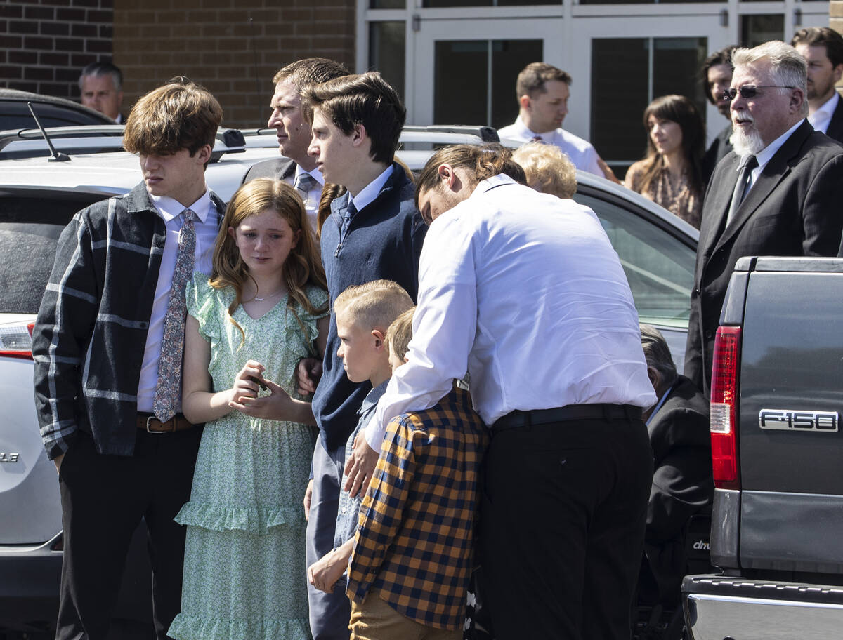 Family members watch as pallbearers carry the casket of Rex Patchett’s, 13, who was fata ...