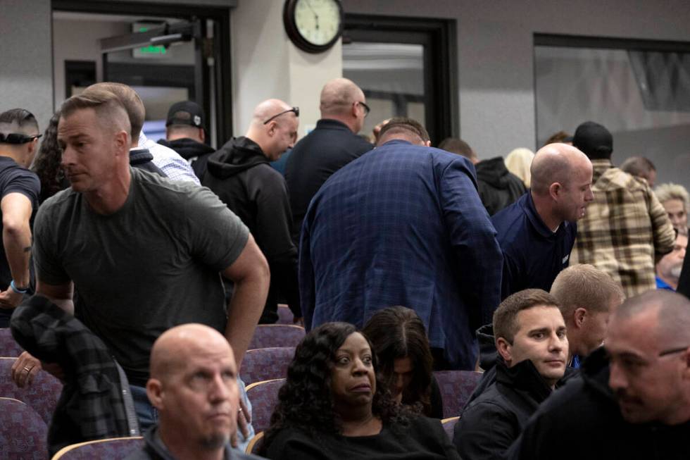 Attendees of a city council hearing get up and leave following comments from Henderson Mayor De ...