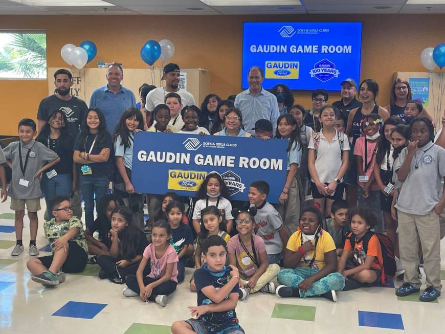 Former Vegas Golden Knight defenseman Ryan Reaves (third adult from left), Gaudin Ford executiv ...