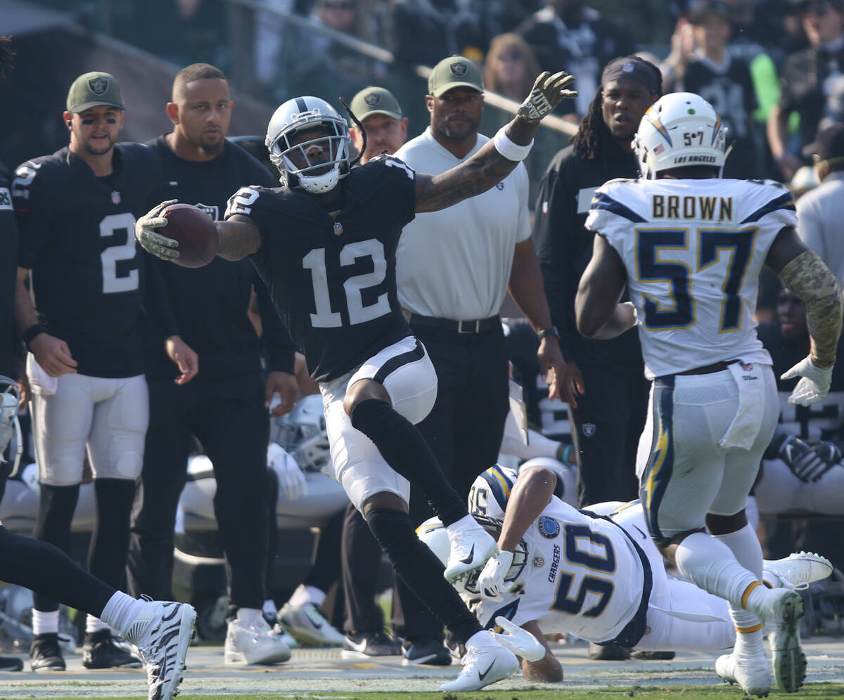 Oakland Raiders wide receiver Martavis Bryant (12) tries to stay in bounds as Los Angeles Charg ...