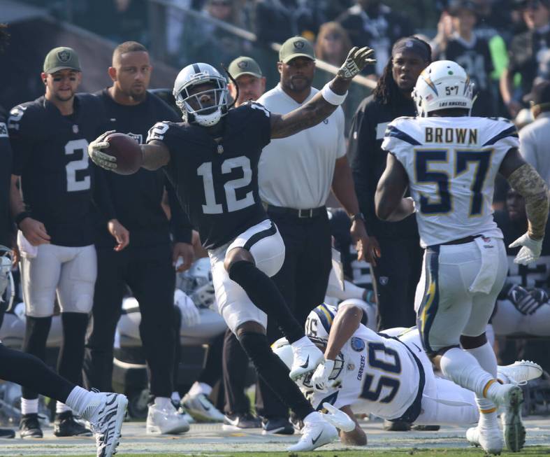 Oakland Raiders wide receiver Martavis Bryant (12) tries to stay in bounds as Los Angeles Charg ...