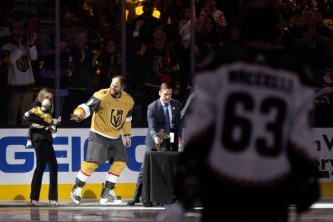 Golden Knights center Phil Kessel (8) waves to his family while being recognized for playing 10 ...