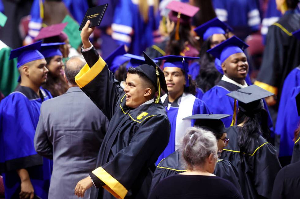 Clark High School student Isaac Juarez, bottom/middle, celebrates with classmates after turning ...