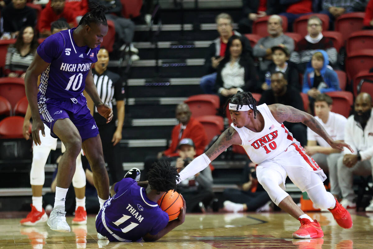 High Point Panthers guard Abdoulaye Thiam (11) wins a loose ball against UNLV Rebels guard Kesh ...