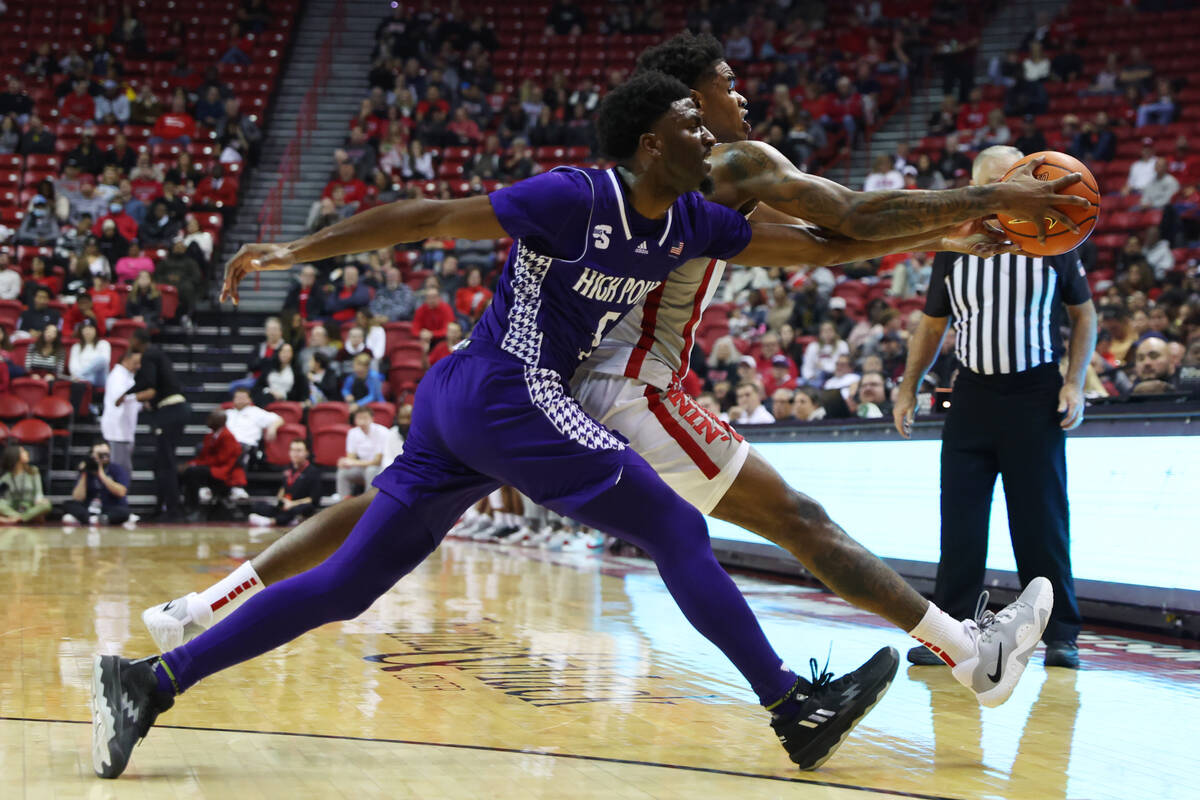 UNLV Rebels guard Luis Rodriguez (15) and High Point Panthers guard Bryant Randleman (5) fight ...