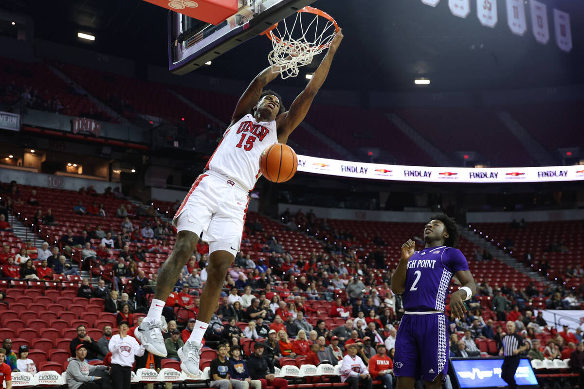 UNLV Rebels guard Luis Rodriguez (15) dunks the ball as High Point Panthers guard Jaden House ( ...