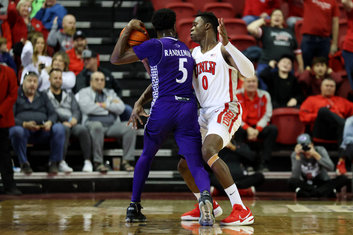 UNLV Rebels forward Victor Iwuakor (0) defends against the High Point Panthers guard Bryant Ran ...