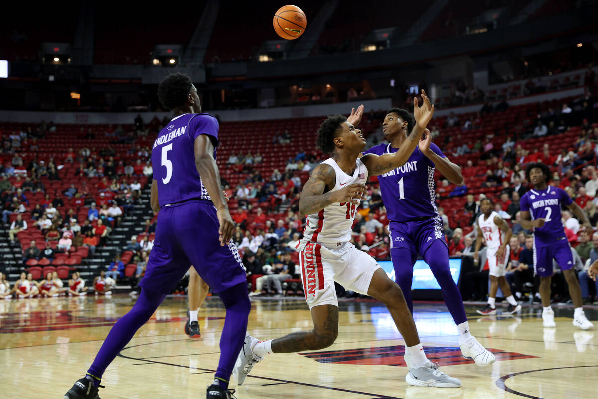 UNLV Rebels guard Luis Rodriguez (15) loses the ball against High Point Panthers guard Bryant R ...