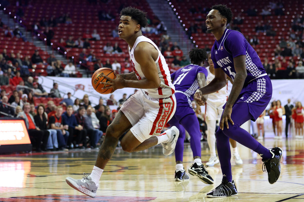 UNLV Rebels guard Luis Rodriguez (15) dribbles the ball to the basket past High Point Panthers ...