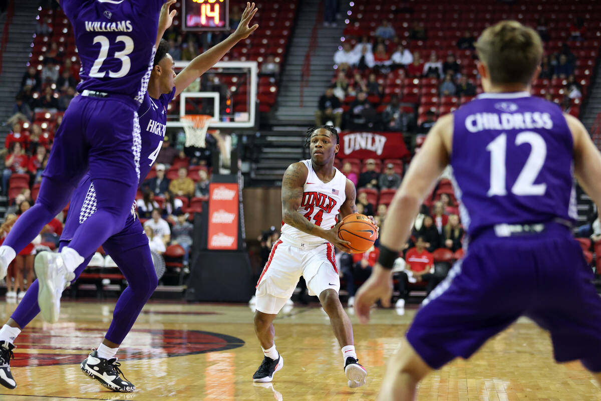 UNLV Rebels guard Jackie Johnson III (24) looks for an open pass against the High Point Panther ...