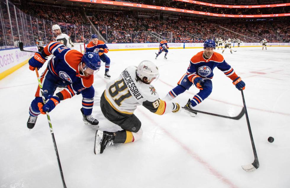 Vegas Golden Knights' Jonathan Marchessault (81) and Edmonton Oilers' Brett Kulak (27) and Evan ...