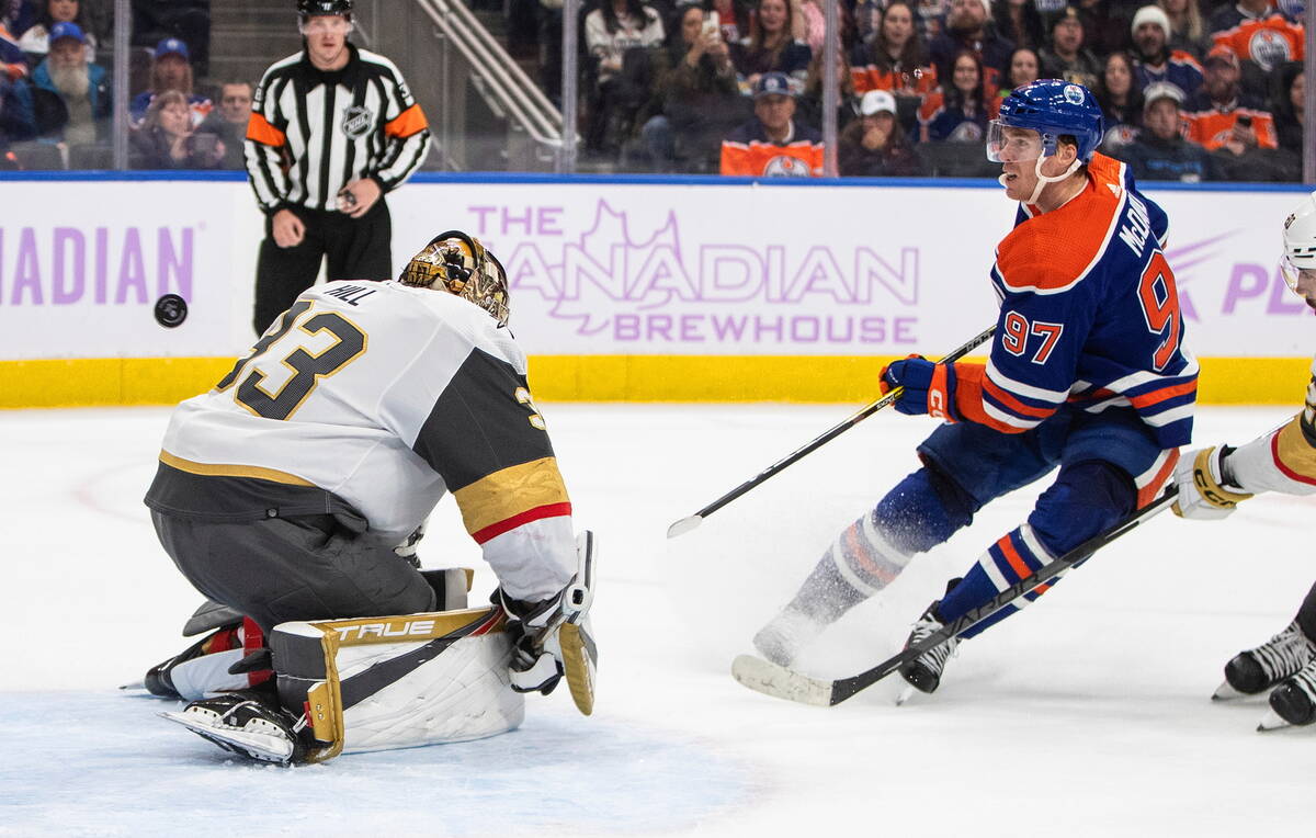 Vegas Golden Knights' goalie Adin Hill (33) gives up a goal to Edmonton Oilers' Connor McDavid ...