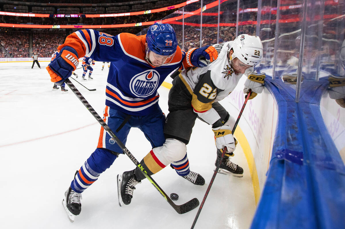 Vegas Golden Knights' Michael Amadio (22) and Edmonton Oilers' Ryan Murray (28) compete for the ...