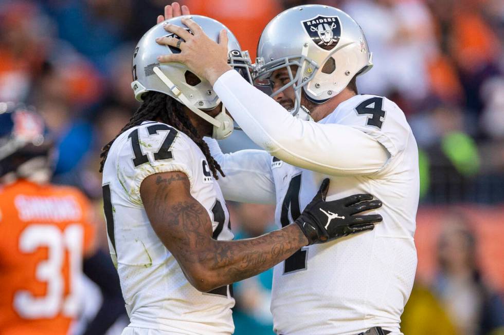 Raiders quarterback Derek Carr (4) congratulates wide receiver Davante Adams (17) after throwin ...