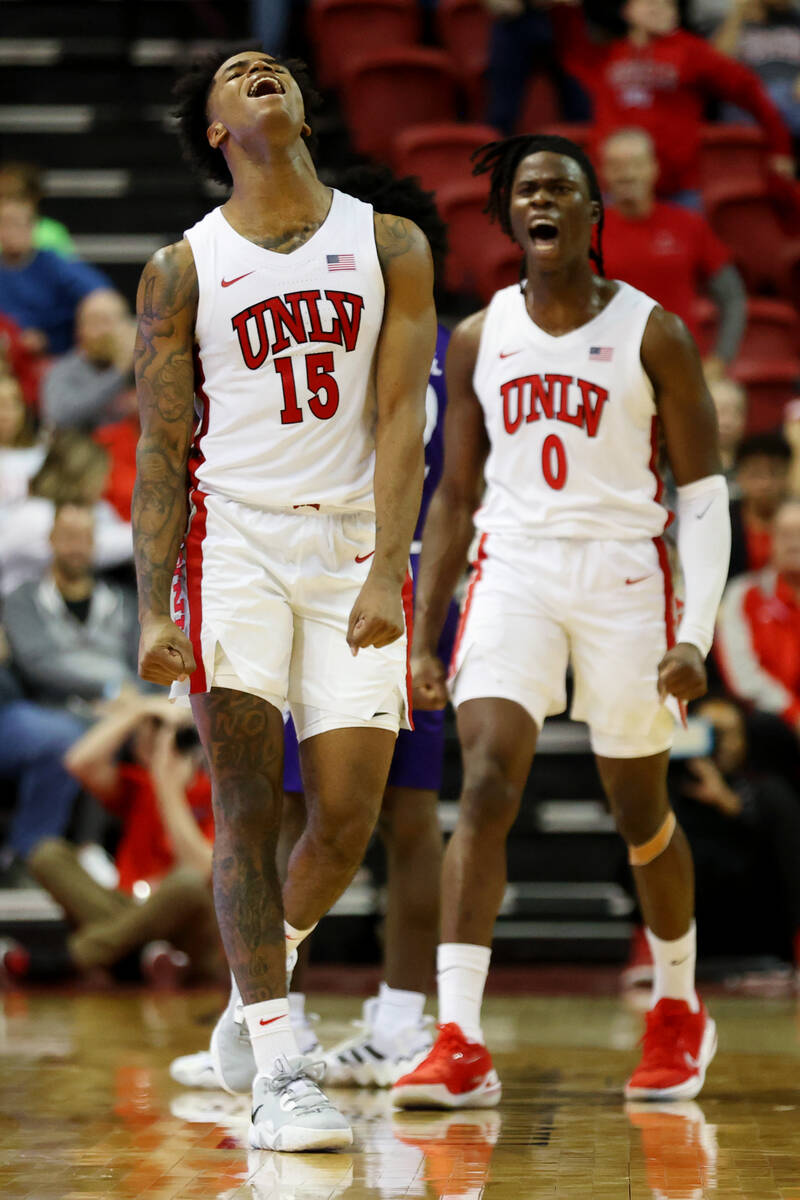 UNLV Rebels guard Luis Rodriguez (15) and forward Victor Iwuakor (0) react after winning posses ...