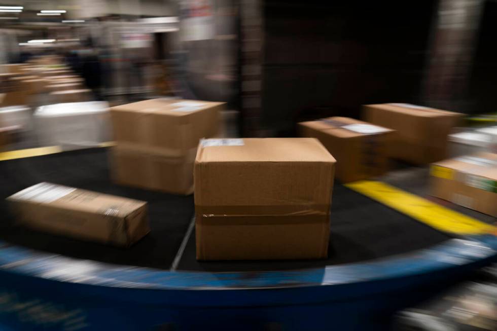 Packages move along a conveyor belt while being sorted for delivery at the FedEx regional hub a ...