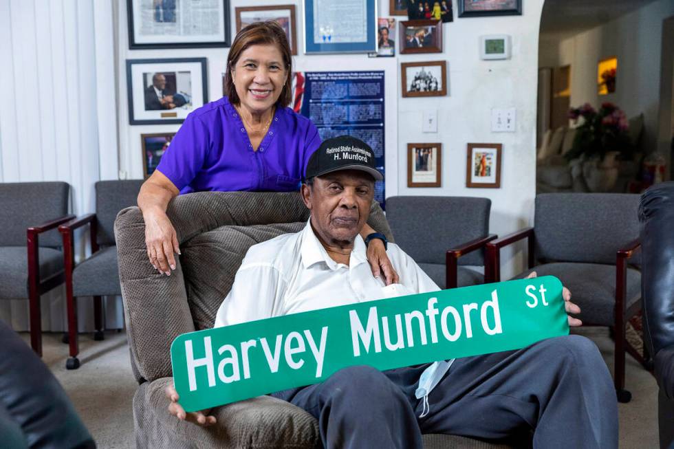 Harvey Munford with his wife Vivian relaxes at home showing off a mock up of his new street sig ...
