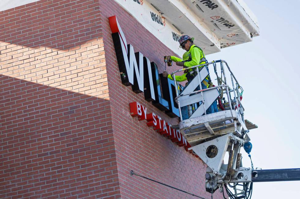 Jeremy Jewell of Hartlauer Signs installs signage for the new Wildfire Casino location at 2700 ...