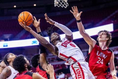 UNLV Rebels forward Victor Iwuakor (0) powers up for a basket over Incarnate Word Cardinals gua ...