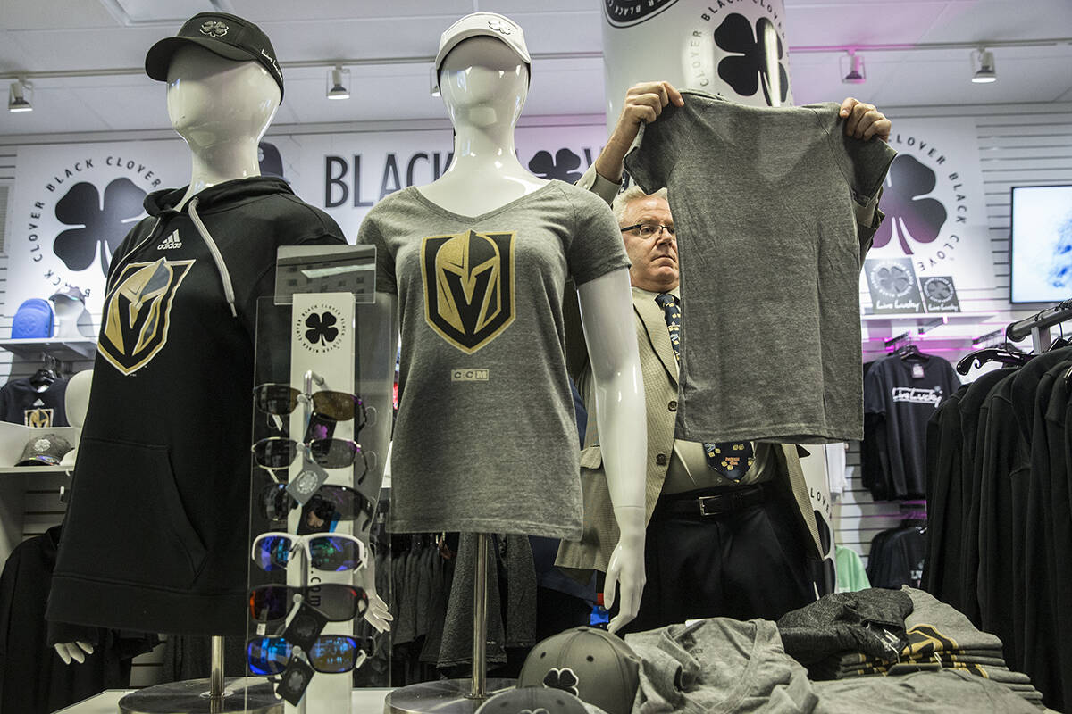 Fans purchase official Golden Knights merchandise at the conclusion of a ceremony to unveil the ...